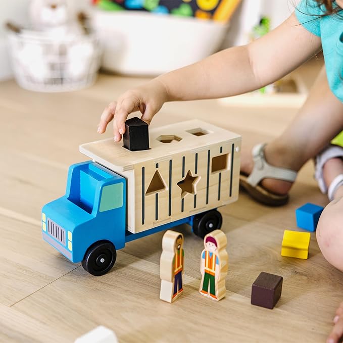 Melissa & Doug Shape-Sorting Wooden Dump Truck Toy, Quality Craftsmanship, 9 Colorful Shapes and 2 Play Figures, 7.5' H X 10.75' W X 4.75' L